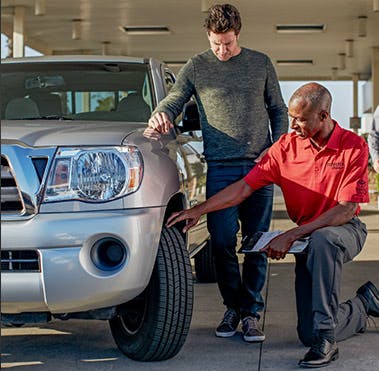 Service technician putting on a new Toyota tire.
