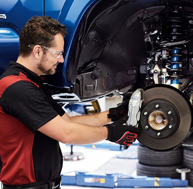 Service technician installing a new brake.